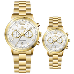 Branded couple wrist watches in pakistan. A pair of gold-toned watches with white analog dials, one large and one small, set against a black background.