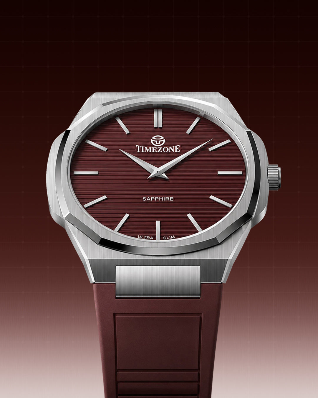 Timezone watch with a silver stainless steel octagonal bezel, a textured dark red dial, and a matching dark red silicone strap, shown against a dark red gradient background.